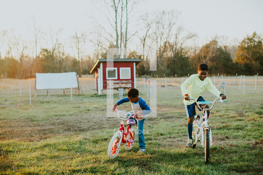 kids riding bikes on a farm 