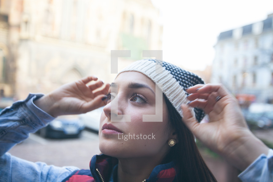 woman adjusting her wool cap