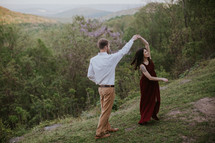 couple dancing on a hillside 