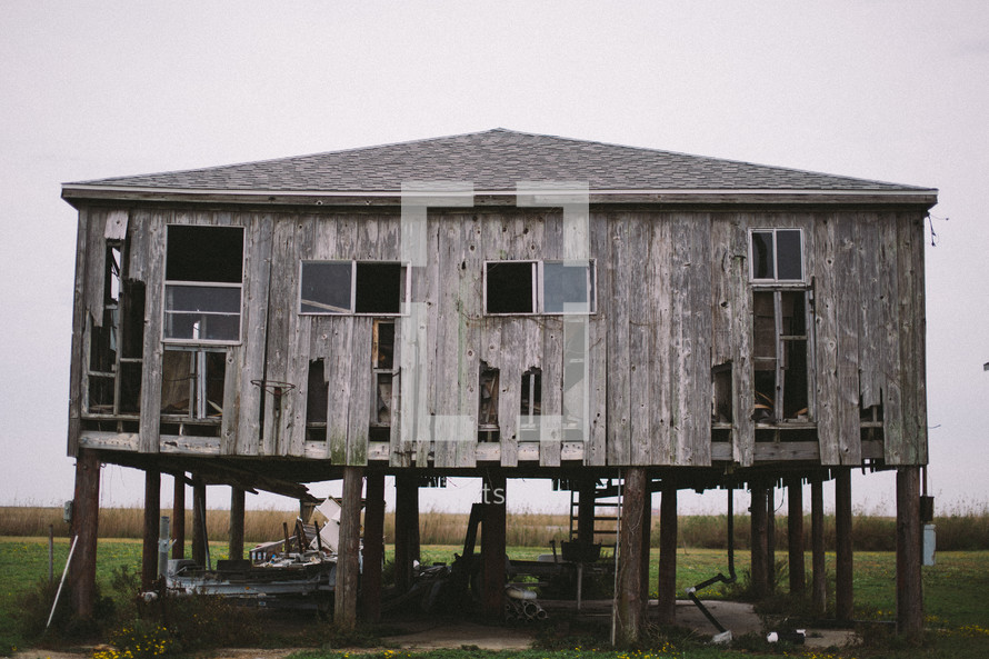 an abandoned house on stilts 