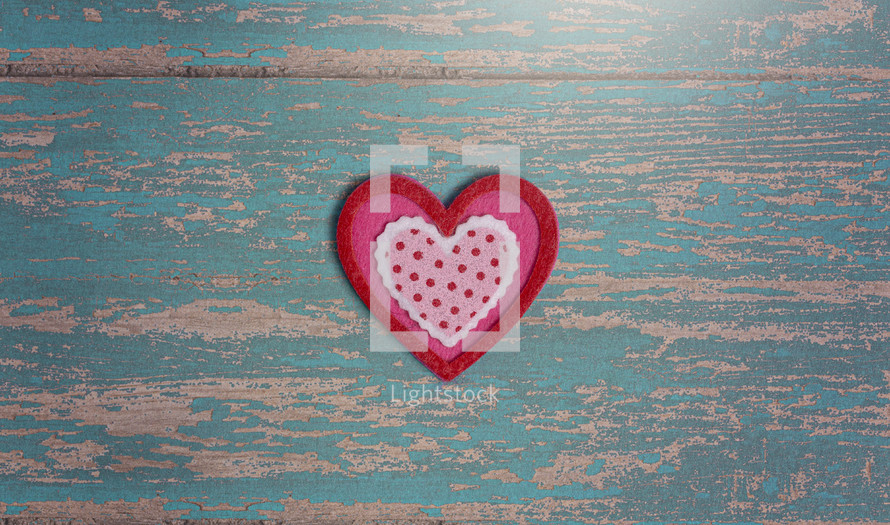 Simple Background with Felt Love Hearts on a Wooden Table