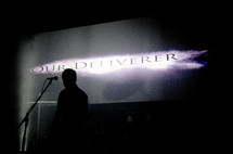 silhouette of a man on stage - our deliverer 