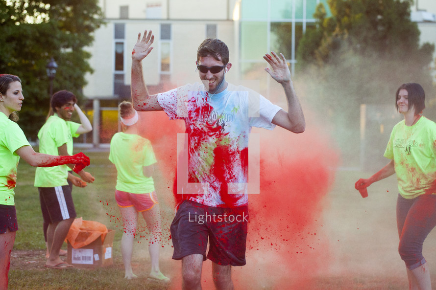 teens tossing colors at a color run
