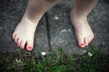 toddler girls feet with her toes painted 