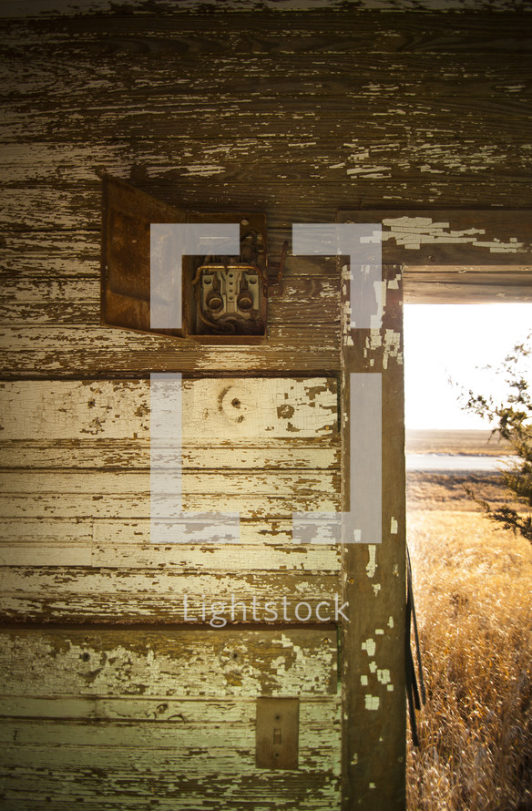 A door frame on an old farm house and pealing paint. 