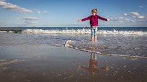 child playing in the ocean 