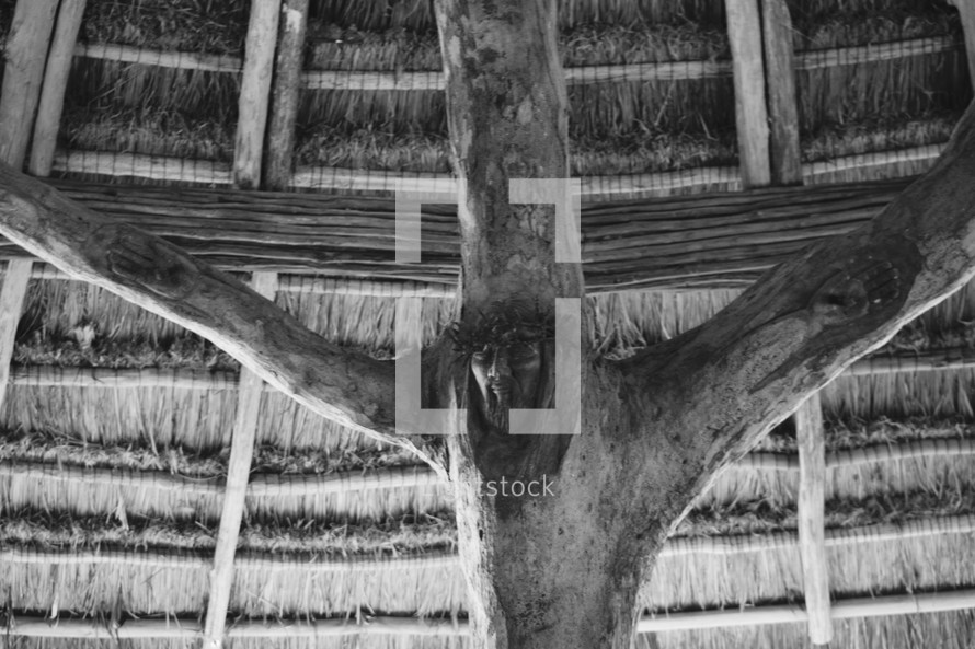 sculpture of Jesus on the cross carved into a tree in the Chapel of Saint Francis of Assisi in Xcaret, Cancun, Mexico 
