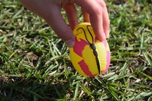 A child picking up an Easter egg at an Easter egg hunt