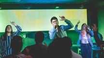 people singing on stage during a worship service 