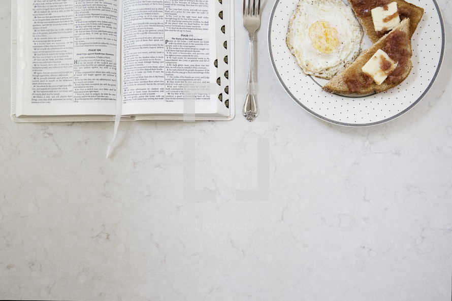 breakfast and morning devotional with open Bible on the table 