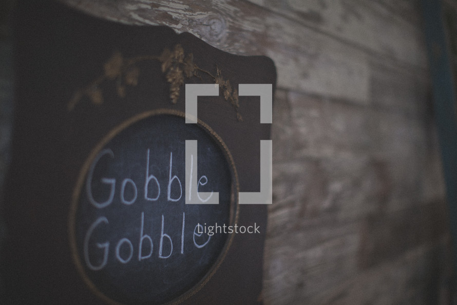 Gobble Gobble written on a chalk board for Thanksgiving