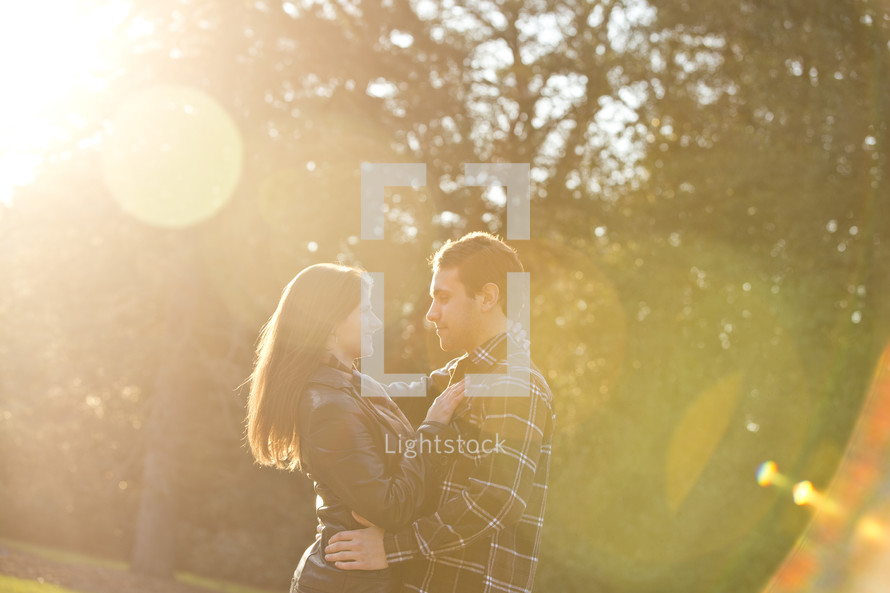 couple hugging under the glow of sunlight