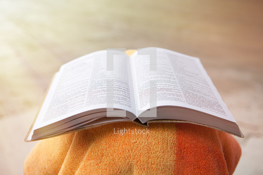 Bible on Beach with Copy Space and Golden Sunlight