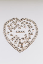 scrabble pieces in the shape of a heart and word love 