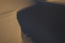 Ridges and patterns carved by wind in a sand dune