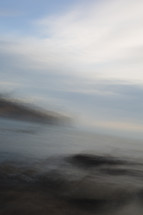 blurry image of ocean and shore