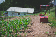 a plow and crops on a farm 