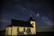 small rural church under stars in the night sky