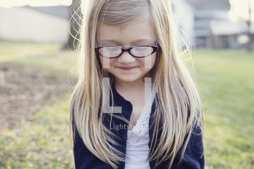blonde little girl in reading glasses 