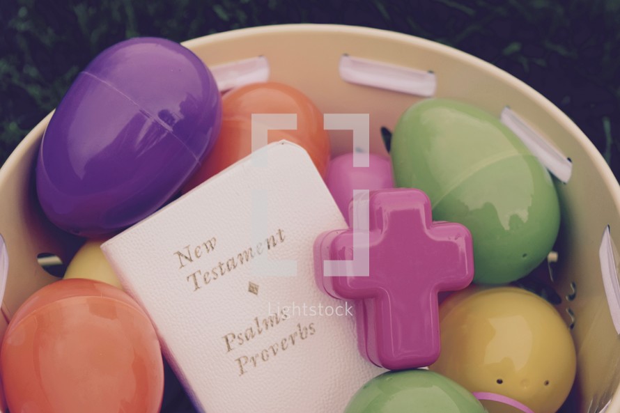 The New Testament Bible in a bucket full of Easter eggs 