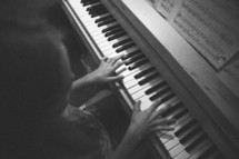 A girl playing a piano. 