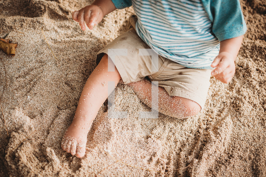 toddler legs in sand 
