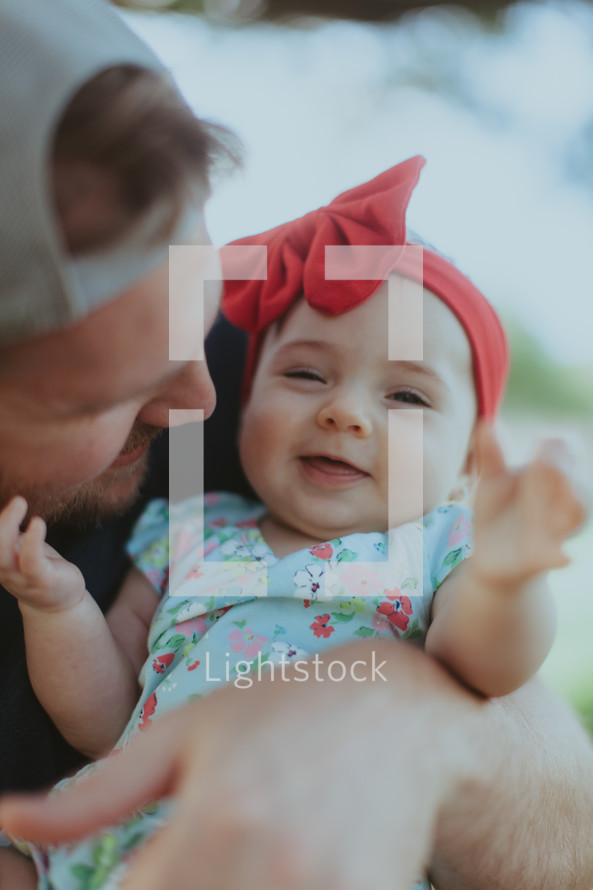 a father holding his infant daughter 