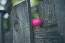 Easter egg on a  wooden fence.
