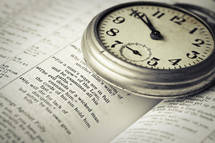 stopwatch on the pages of a Bible