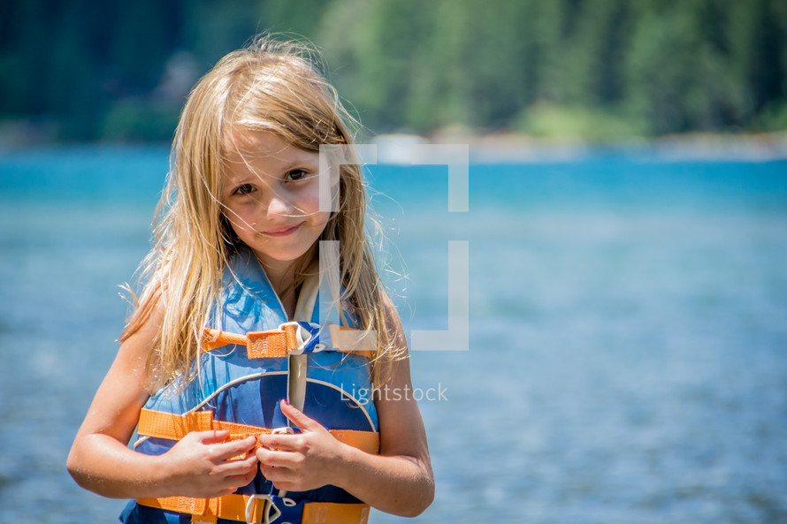 girl child wearing a life vest 