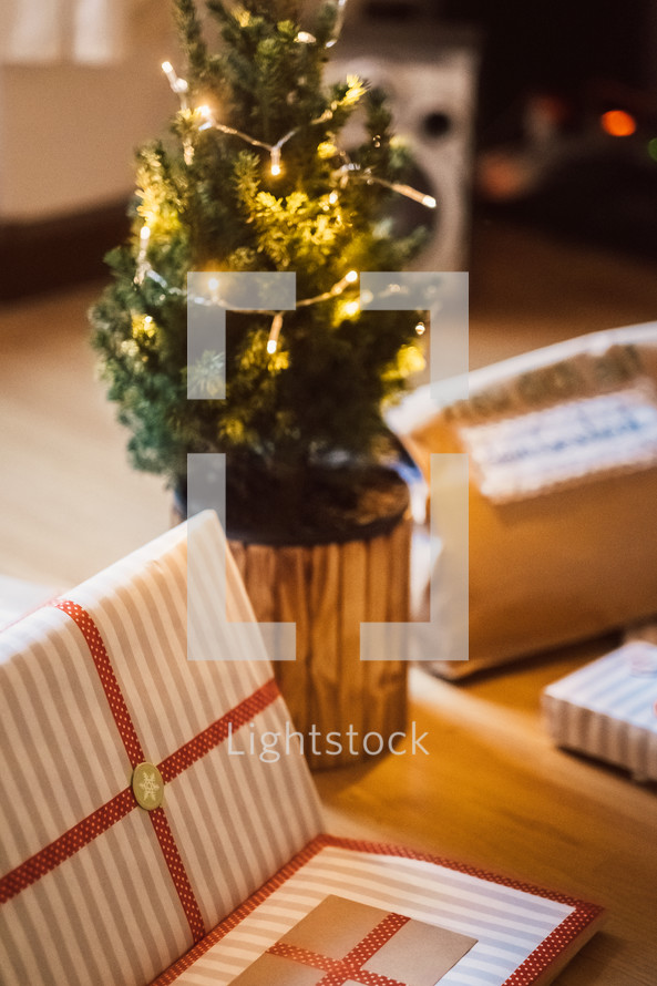 Christmas gifts around a tiny Christmas tree
