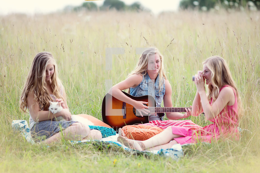 women sitting in a summer field 
