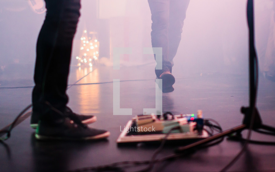 guitar pedals on stage at a concert
