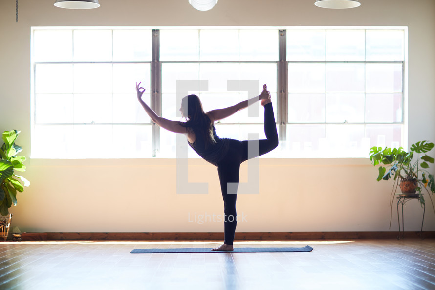 woman stretching in a yoga studio 