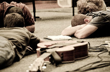 Musicians in a prayer circle on the floor.