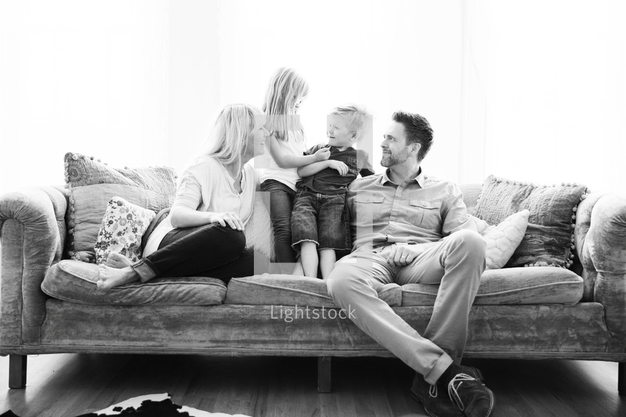 portrait of family sitting on a couch 