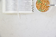 open Bible and bowl of milk and cereal 