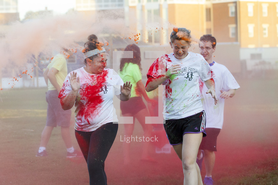 teens running in a color run 