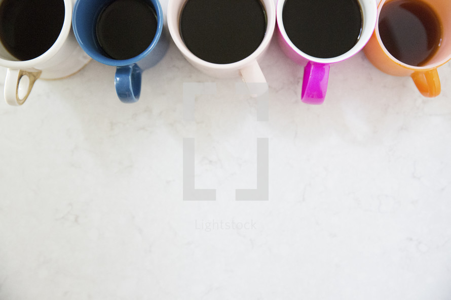 row of colorful coffee mugs 