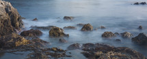 Ocean mist in the shoreline rocks.