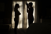 silhouette of an arguing couple.