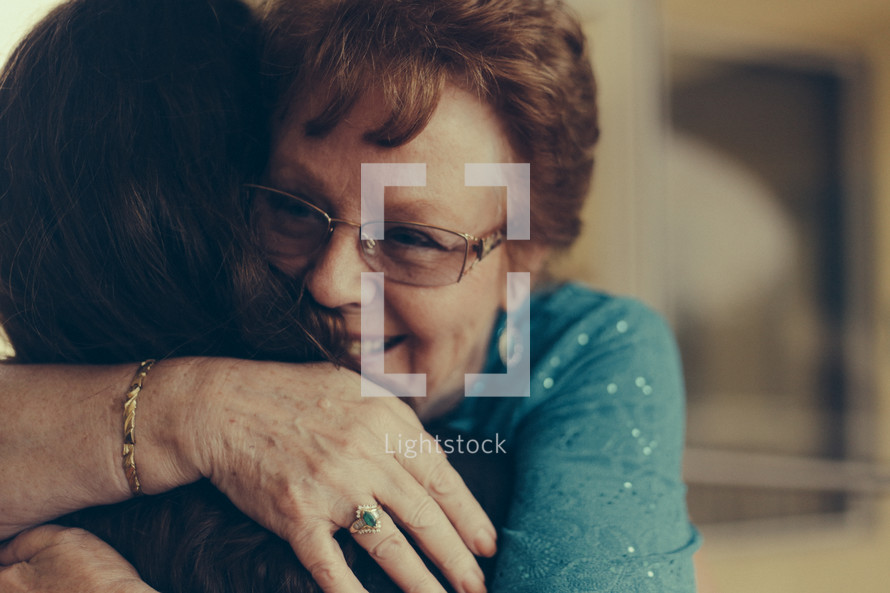 a tender hug between two women 