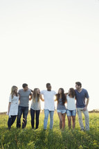 group of young adults standing outdoors 