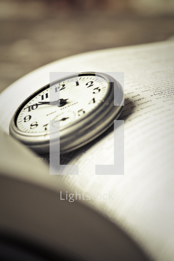 stopwatch on the pages of a Bible
