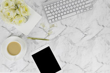 Carrara marble, iPad, computer keyboards, pen,  paperclips, gold, white, coffee cup, roses, watch, journal, copy space 