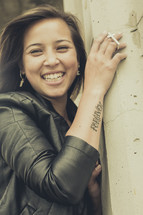 smiling woman with a forgiven tattoo 
