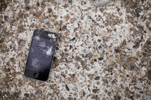 Broken iphone on a granite counter top.