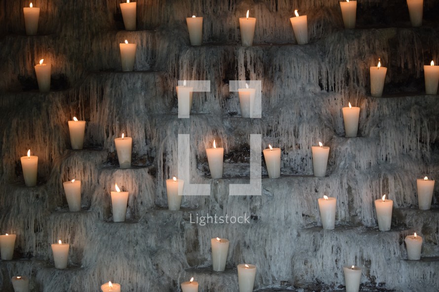 melting wax dripping down the walls in a candelarium used for prayer, day of the dead, dia de los Muertos  