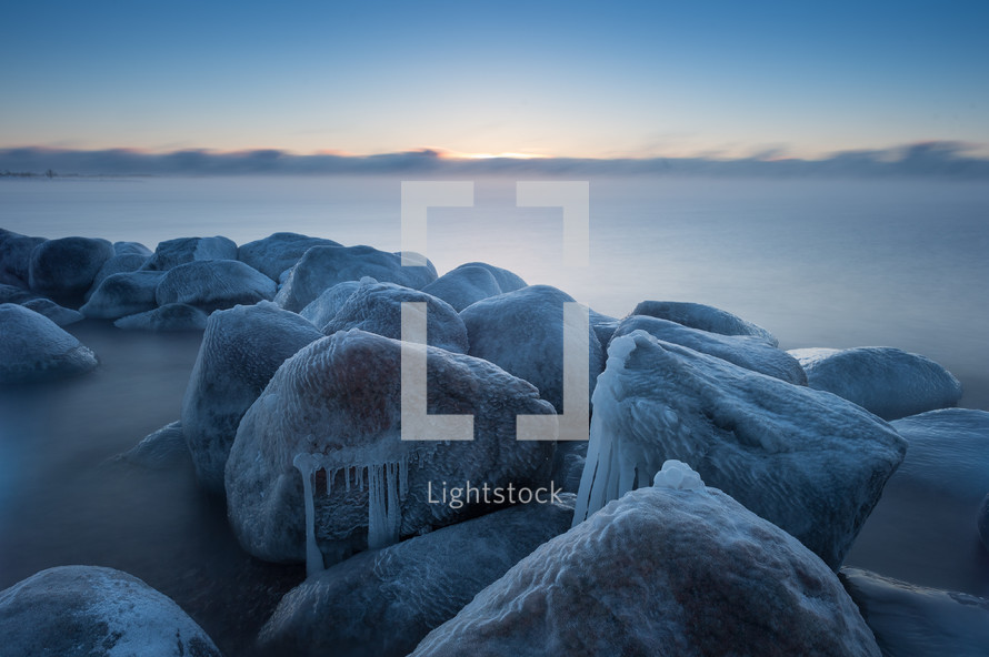 ice on stones along a shore 