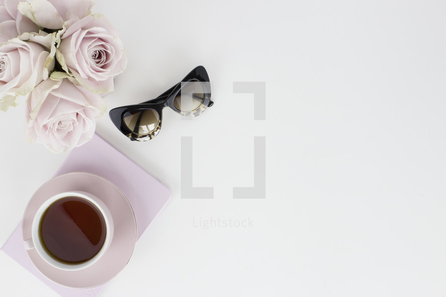roses, sunglasses, coffee mug, and journal 